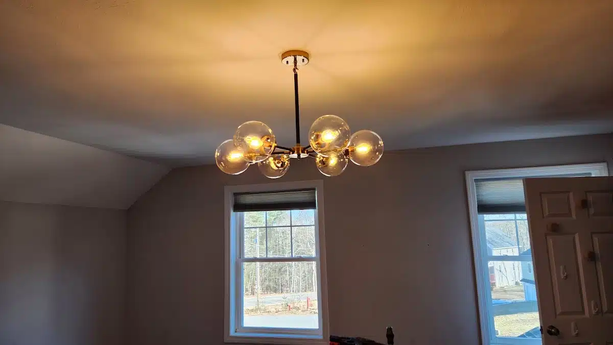 Modern globe chandelier installed in a living room