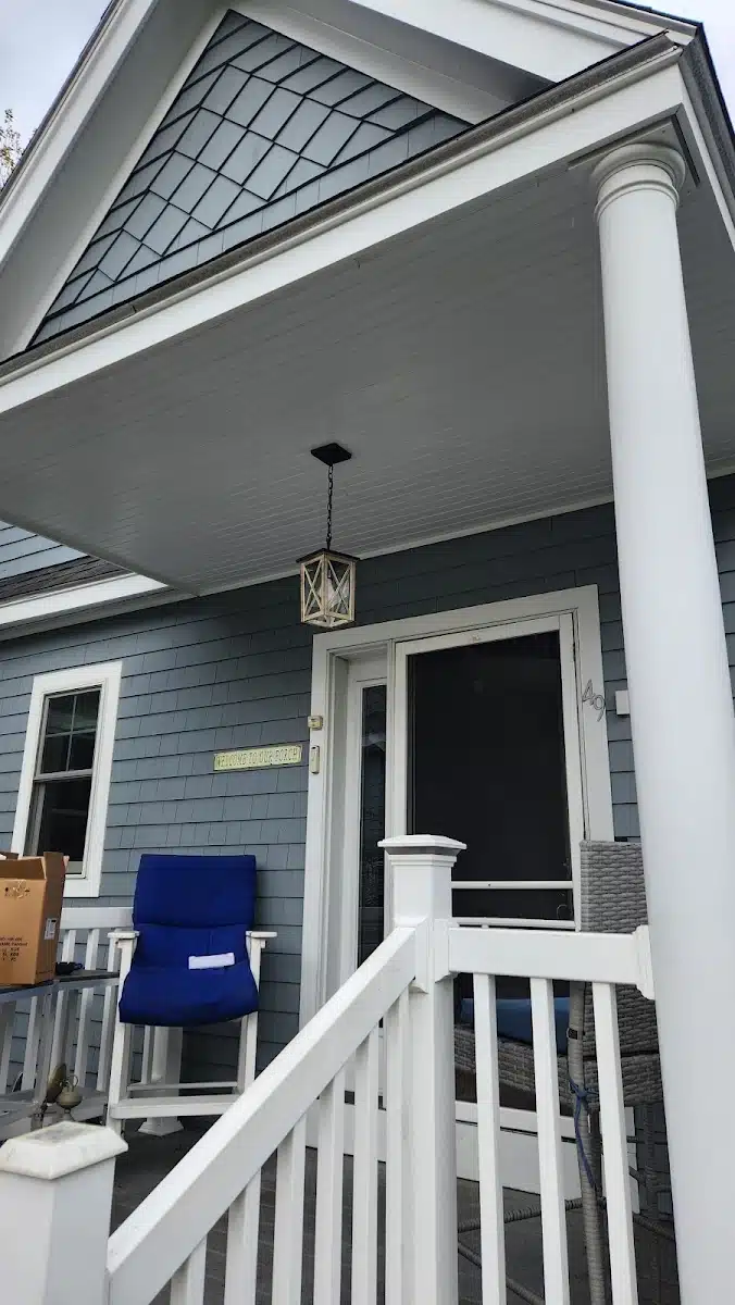 Lantern-style porch light installed over a front entry