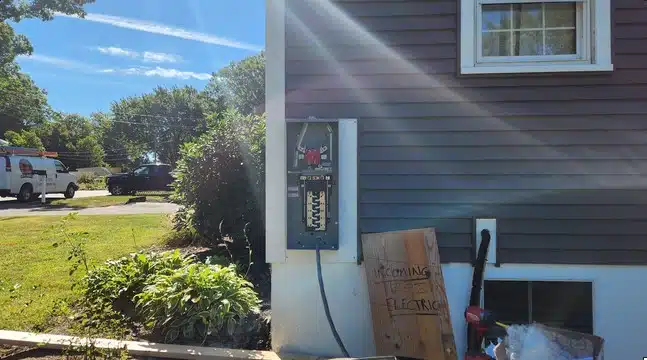 Old electrical service removed and new meter socket mounted on the side of a house